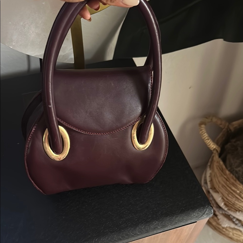 Elegant Burgundy Handbag with Gold Accents